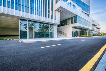 Empty asphalt road and commercial office buildings in modern city