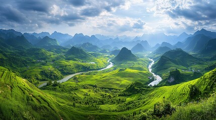 Naklejka premium A breathtaking view of a winding river through lush green valleys and mountains in a serene landscape at dawn