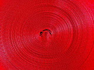 red ribbon roll surface background. detailed texture of polyester material.
