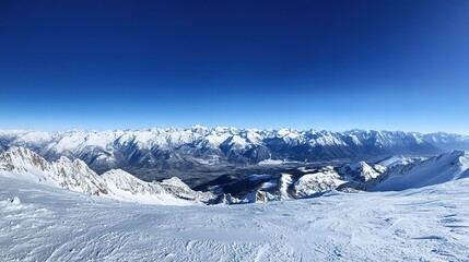 Expansive view of a snowy mountain landscape under a bright blue sky with fluffy clouds during the daytime in winter