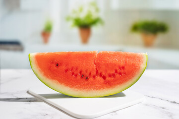 On the kitchen table, a juicy slice of watermelon in the brilliant sunbeams.