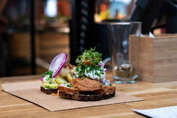 Smorrebrod, a classic Danish open-faced sandwich, features a slice of dark rye bread topped with a meatballs.