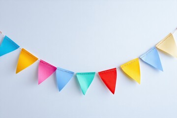 Colorful paper bunting flags hanging on light background