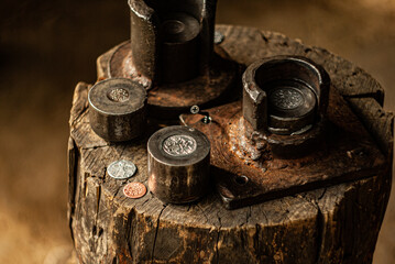 Minting of coins on a stand. Close-up of minting coins. Embossed gold and silver coins
