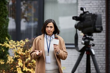 A multiracial female journalist speaks into a microphone, capturing the essence of breaking news...