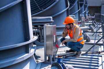engineer under checking the industry cooling tower air conditioner is water cooling tower air...