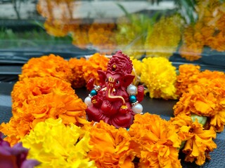 Lord Ganesha decorated with flowers beautiful red color ganpati bappa detailed sculpture, cute...