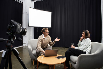 A knowledgeable journalist conducts a professional interview with a specialist in a modern studio...