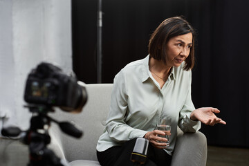 A focused journalist capturing expert insights in a contemporary studio atmosphere.