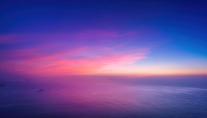 Obraz premium Dreamy Sunset Horizon with Soft Pastel Clouds Reflecting Over Calm Ocean Waters and a Solitary Island Silhouette in the Distance