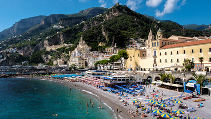 Visitors bask in the sun along the vibrant Amalfi Coast, surrounded by stunning cliffs, colorful...