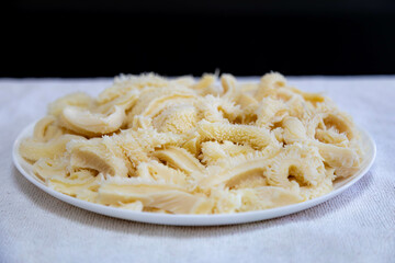 Beef tripe (bucho), beef stomach, tripe on a white plate. Dobradinha