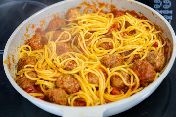 Traditional spaghetti with tomato sauce and meatballs and grated parmesan cheese