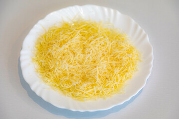 Grated parmesan cheese on a white plate. Pecorino Romano cheese