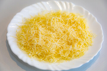 Grated parmesan cheese on a white plate. Pecorino Romano cheese