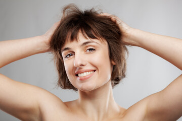 Fototapeta premium beauty portrait of a brunette girl with short hairstyle. hands in the hair