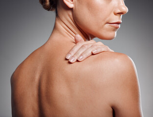Body, skincare and model with self care, dermatology and beauty on gray studio background. Woman,...
