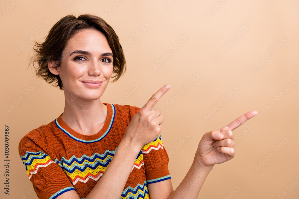 Sticker Portrait of gorgeous friendly person indicate fingers empty space ad blank isolated on beige color background