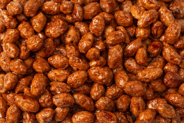 Tasty sweet roasted peanuts as a background.