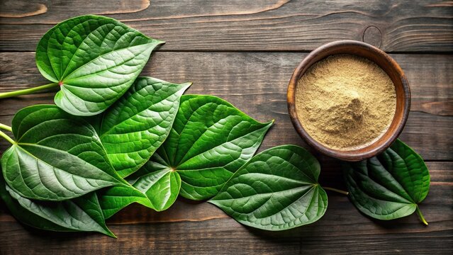 Freshly picked kava kava leaves with a small bowl of kava powder aerial view