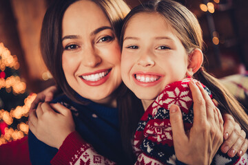 Photo of nice small daughter mother cuddle cheerful smile wear christmas clothes enjoy cozy x-mas...