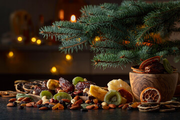 Dried tropical fruits and Christmas tree on a kitchen table.