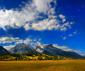 Grand Teton Mountains Tetons in Wyoming Rugged Mountain Range in Autumn Fall Landscape with blue sky and clouds