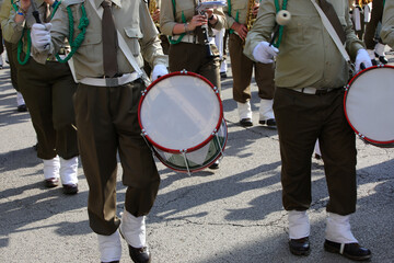 Many drummers marching in uniform during the parade through the streets with the marching band