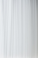 Obraz premium white curtain that dropped down as a straight line. Background for inserting text, empty spaces 