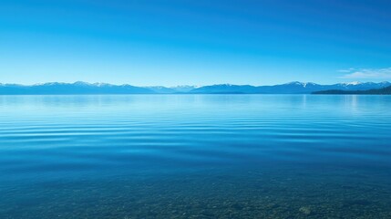 Fototapeta premium The calm waters of Lake Tahoe with a clear, open sky for copy
