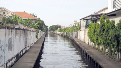 Canal walkway as a thoroughfare Of people living in houses along Saen Saep canal, Thailand. Canal Cement walkway.