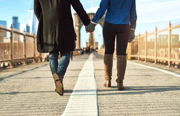 Couple, holding hands and walking in city on vacation, honeymoon adventure and connect on street....