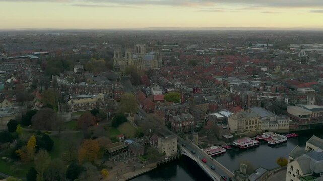 Drone shot capturing the cityscape of York with historic buildings and River Ouse during sunset, England, UK