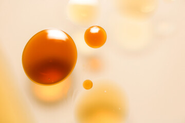 Yellow circular oil droplets floating on the water.