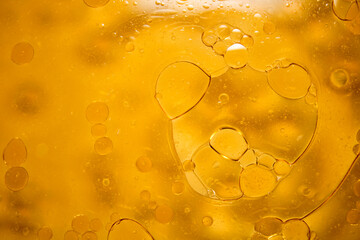 Abstract image of air bubbles and golden oil drip texture.