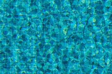 The Tranquil Dance of Sunlight Across Shimmering Turquoise Water in a Serene Swimming Pool on a Bright Summer Day