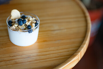 Healthy breakfast. Bowl of greek yogurt with oat granola, fruits, nuts, honey and chia seeds. Top view. Diet food