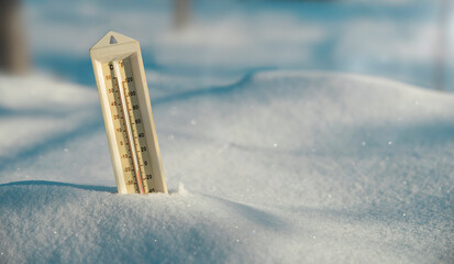 Weather thermometer with fahrenheit and celsius measurement temperature stuck in a snowdrift. Forecast concept.