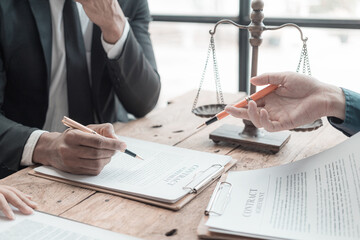 Male lawyer working with contract documents and wooden hammer on table in courtroom justice and law...