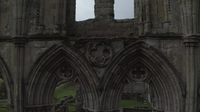 Drone shot of Rievaulx Abbey ruins with gothic architecture and scenic landscape in Helmsley, England, UK