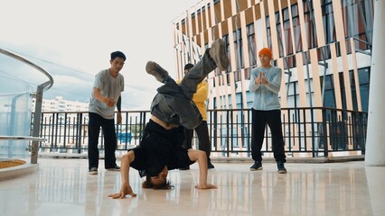 Hip hop team dance break dance while multicultural friend surrounded and clapping hands to cheer or...