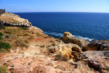 wooden walkway on algar seco amidst beautiful rock formations in Carvoeiro, Lagoa, Algarve, Portugal