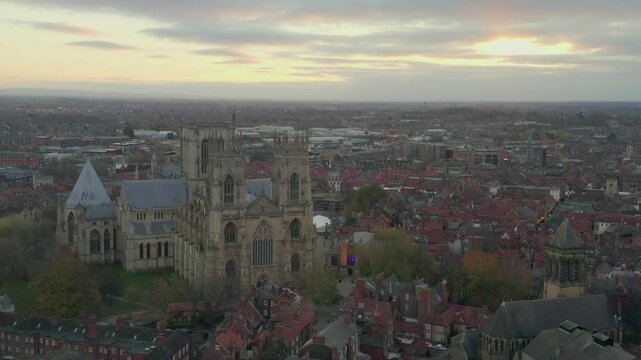 Drone shot of York Minster with surrounding cityscape at sunset in York, England