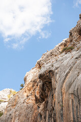 Majestic rocky cliff against a sky, showcasing rugged natural beauty
