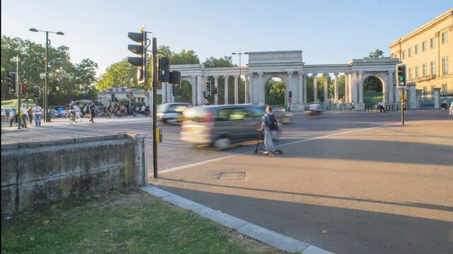 Timelapse video of cyclists and pedestrians crossing the street at Hyde Park Corner on a sunny day in London, UK