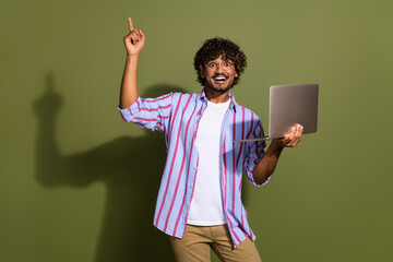 Photo of clever genius guy with wavy hair dressed striped shirt in glasses holding laptop have idea...