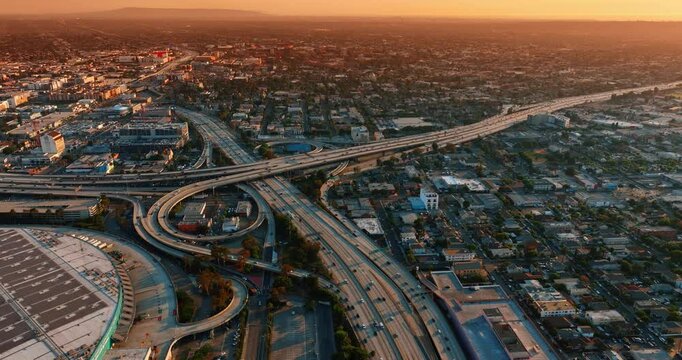 Flow of cars moving to and from city center of Los Angeles, California, USA. Aerial perspective on the metropolis at sunset.