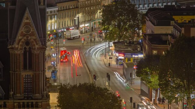 Time lapse of Kings Cross traffic at night with light trails from moving vehicles in London, UK