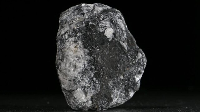 Baryte / Barite (barium sulphate) rotating slowly against a black background [UK]