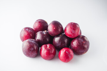 Isolated Summer Plums: Fresh and Juicy Red and Black Plums on a White Background